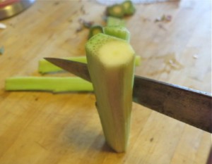 Trimming artichoke stem to reach the core