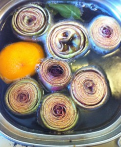 baby artichokes cooking in acidulated water