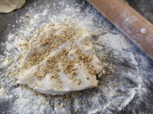 adding nuts to pie dough